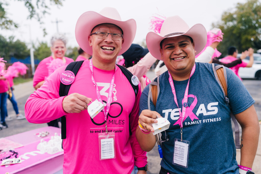 Two men in pink cowboy hats at the 2024 Dallas/Fort Worth Komen 3-Day