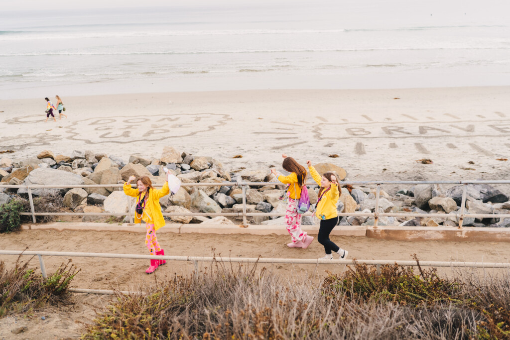 Youth Corps walking alongside the sand art at the 2025 San Diego 3-Day.
