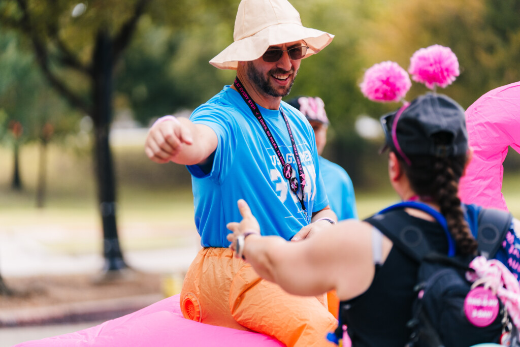 A volunteer giving support to a walker at the 2025 Dallas/Fort Worth 3-Day.