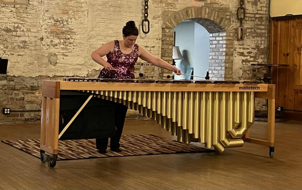 Alyssa S. on stage at her percussion recital playing the marimba.