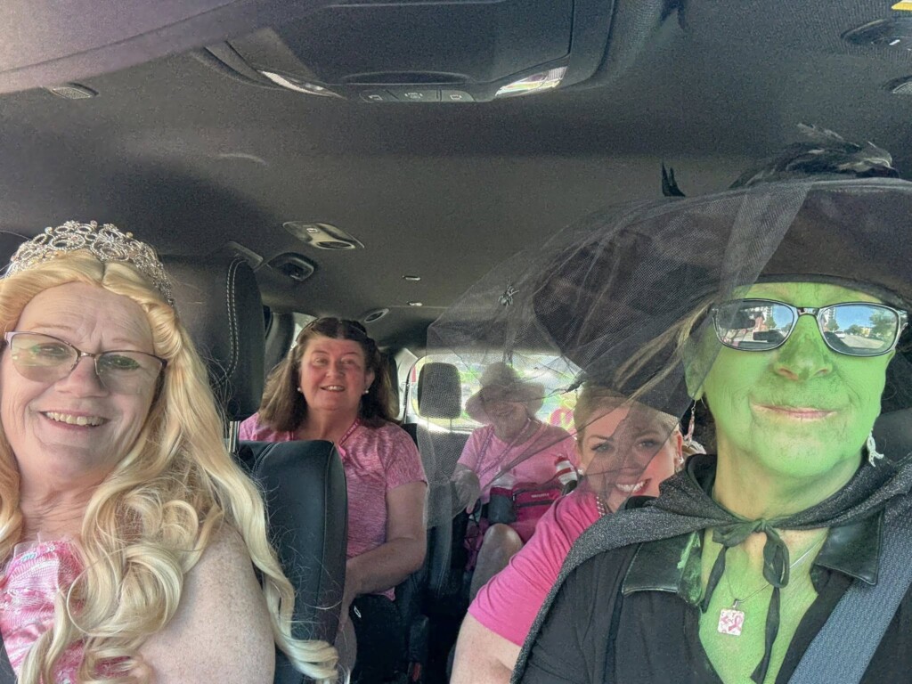 Donna and Denise behind the wheel of their 3-Day sweep van dressed in costume.