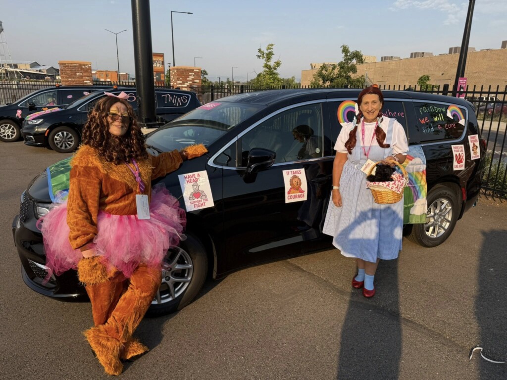 Denise and Donna dressed in costume near their Wizard of Oz sweep van at the Komen 3-Day.