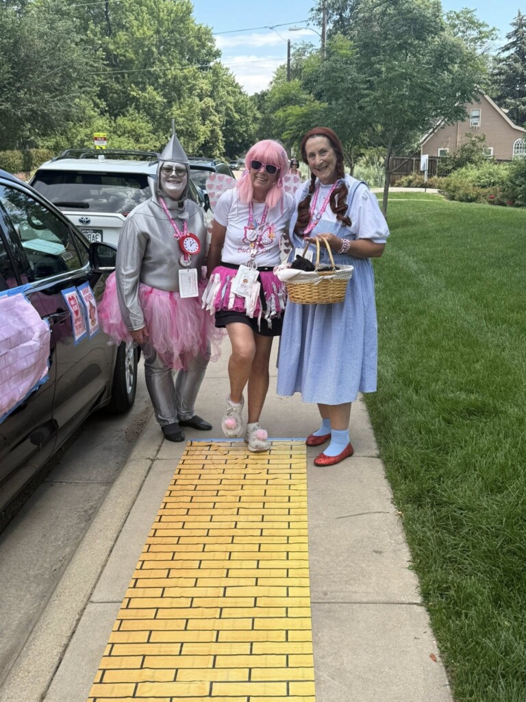 Denise and Donna outside their sweep van on the yellow brick road they set up.